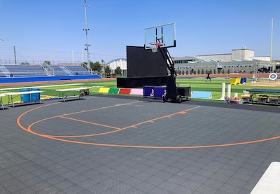 portable basketball court on turf football field