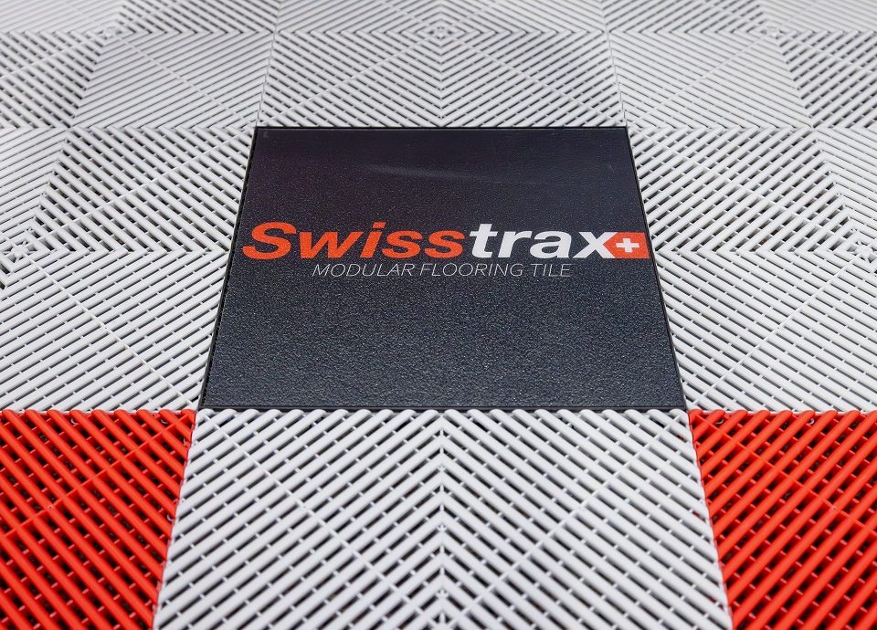 Tile panel floor with Swisstrax Logo