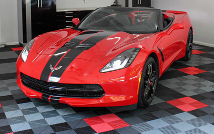 Red sports car parked on-top of Swisstrax garage floor tiles